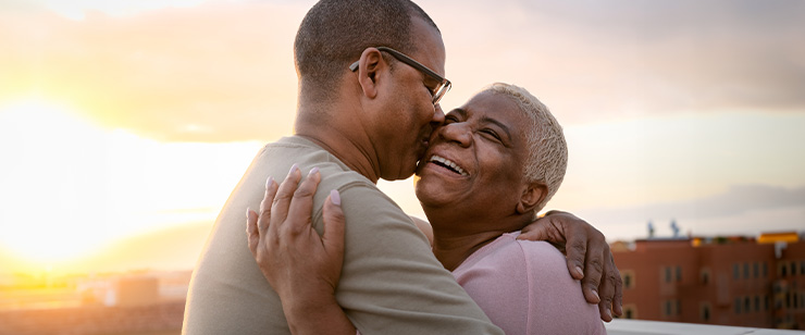 Image of an older man and woman hugging