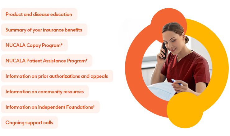 Female doctor wearing maroon scrubs on the phone looking at a clipboard